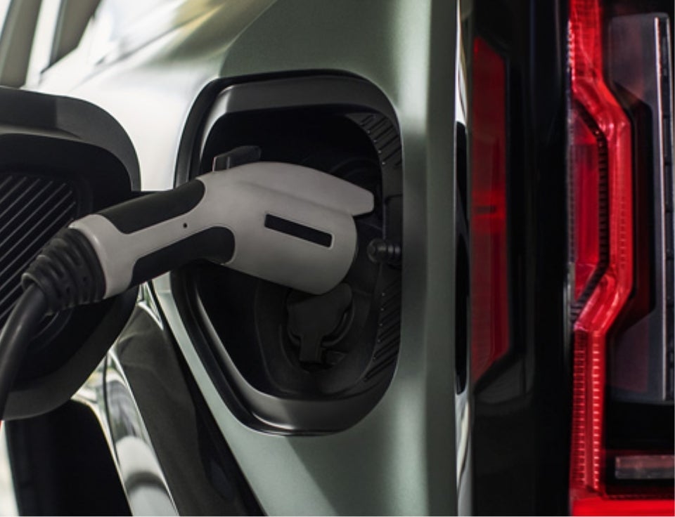 Close up of charging port with charger plugged in on a GMC Hummer EV SUV - Alpine Motor Co in PONDERAY ID